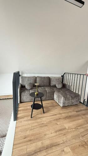 a living room with a couch and a table at Sosina Dreams in Jaworzno