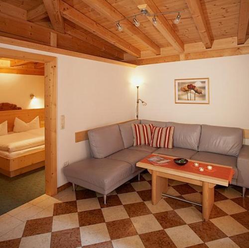 a living room with a couch and a table at Apart Ehart in Sankt Anton am Arlberg