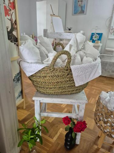 a basket of towels on a table in a room at Bed in mixed room of 3 to 4 or private room for 3 to 4 in Zizur Mayor