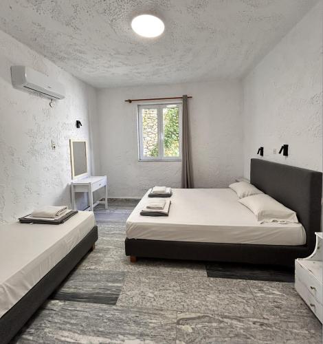 a bedroom with two beds and a window at Matala Hostel in Matala