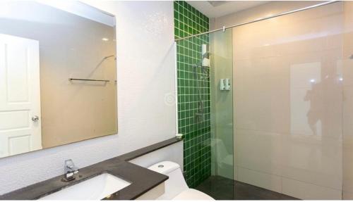 a bathroom with a sink and a glass shower at Gypsy Sea View Resort- Phi Phi Island in Phi Phi Islands