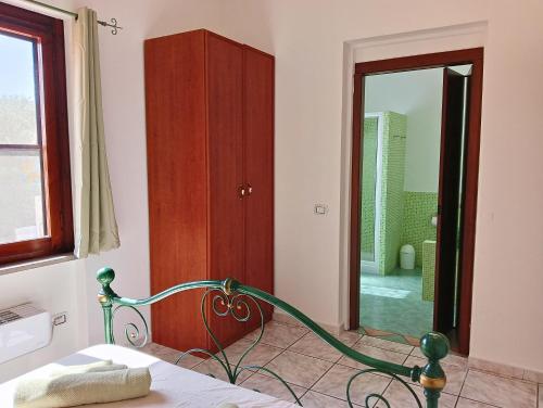 a bedroom with a bed and a large mirror at Casa Misè in Poggio Dei Pini