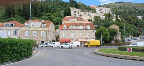 a city street with cars parked on the road at Apartment Mia in Dubrovnik