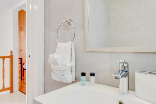 a bathroom with a sink and a white towel at Salt & Sun Retreat in Perivolia