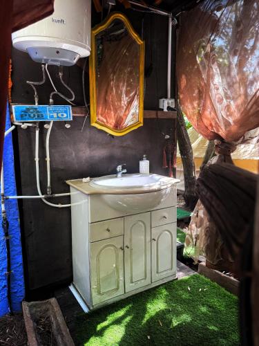 a bathroom with a sink and a mirror at Bell Tent Lovers by Casa das Artes in Luz de Tavira