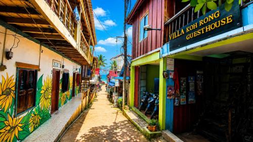a narrow street with colorful buildings in a city at Villa Koh Rong in Koh Rong Island