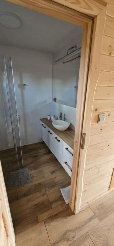 a bathroom with a sink and a mirror at Chatki U Hanusi in Czchów