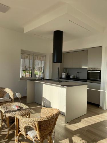 a kitchen with a counter and a table and chairs at Casa Adriano-Dimora per vacanze in Ripa Teatina