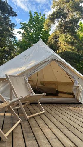 a couple of chairs and a tent on a deck at Merevaatega Glämping Sarvel in Kukka
