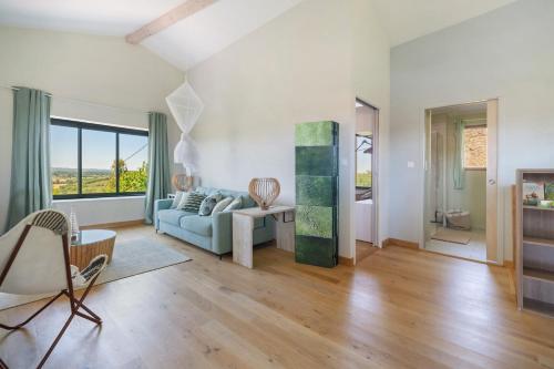 a living room with a couch and a table at Le Logis des Abeilles in Lapenne