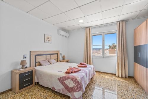 a bedroom with a bed and a large window at Paz en Orihuela in Orihuela