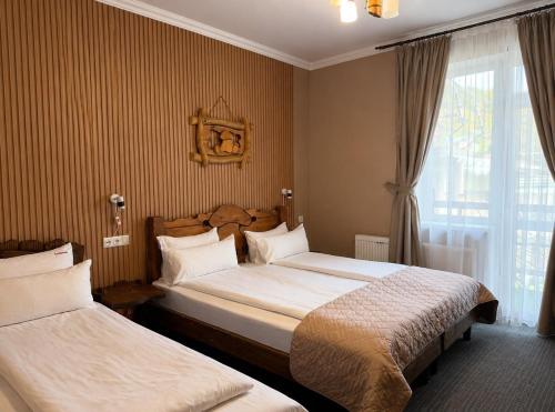 a hotel room with two beds and a window at Silveroks Hotel in Bukovel