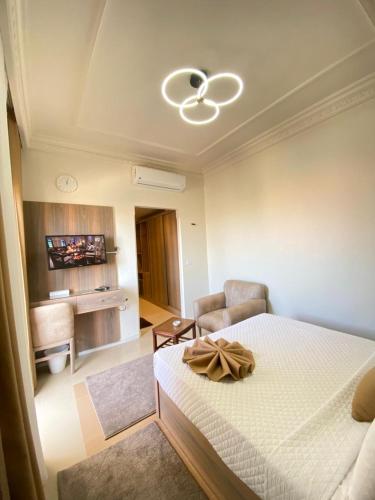 a bedroom with a bed and a living room at Teba Hotel Ras Elbar in Ras El Bar