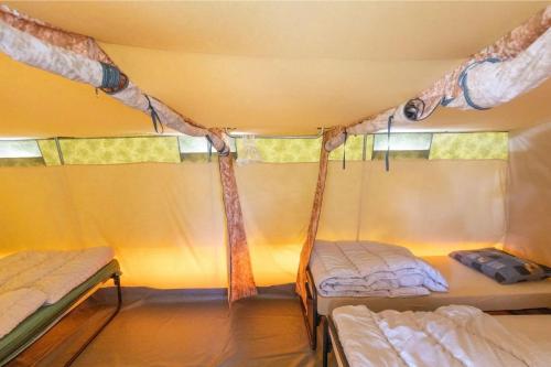 a room with two beds in a tent at Glamlodge Ameland direct aan het strand in Nes