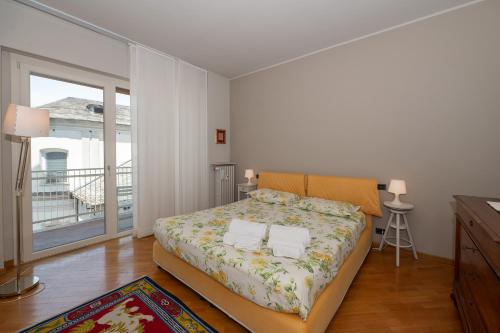 a bedroom with a bed and a balcony at La Basilica in Verbania