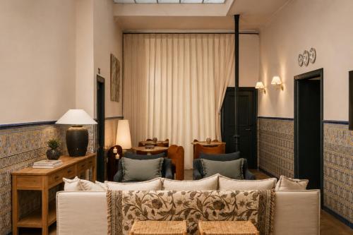 a living room with a couch and chairs at Honest Sevilla Hotel in Seville