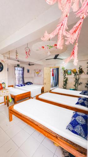 a bedroom with three beds in a room at Backpackers Hub in Dimapur