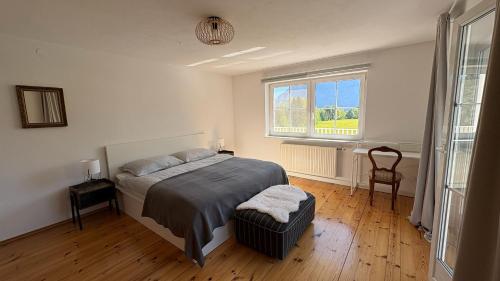 a bedroom with a bed and a window at Panorama Haus am Traunsee in Traunkirchen