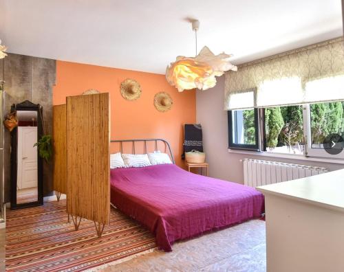 a bedroom with a bed with a purple blanket at Begur "Casa es Pou" in Begur