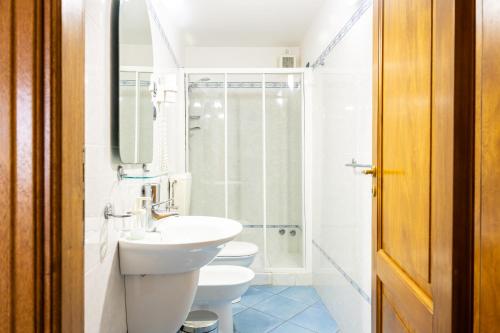 a bathroom with a sink and a toilet and a shower at Villa Artemis by Isula in Lipari