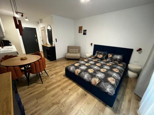 a bedroom with a bed and a table and a dining room at Marina Portovo in Gdańsk