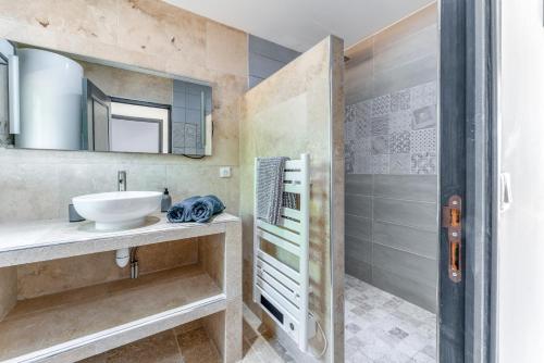 a bathroom with a sink and a shower at Mas Delorme 2 in Arles