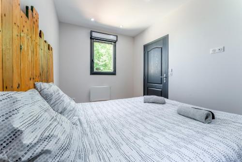 a bedroom with a large bed and a window at Mas Delorme 2 in Arles