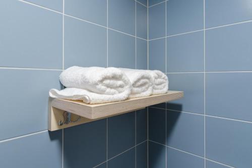 a shelf in a bathroom with towels on it at Märjamaa spordihoone in Märjamaa