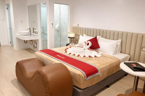 a hotel room with a bed with a swan decoration on it at Mayumi Lodge in Puerto Princesa City