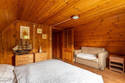 a bedroom with two beds in a wooden cabin at Leśny Raj in Świętajno