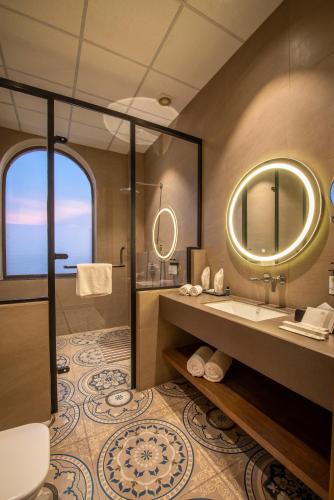 a bathroom with a shower and a sink and a mirror at Tree of Life Ganga Dwar, Haridwar in Haridwār