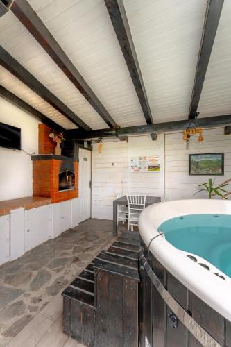 a jacuzzi tub in a room with a table at Cabana Diana in Avrig