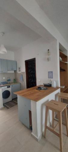 a kitchen with a wooden counter top in a room at MUSHROOMs1 AFYTOS in Afitos