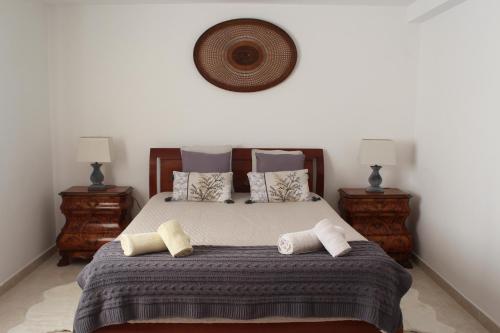 a bedroom with a large bed with two night stands at Campo Dias in Silves