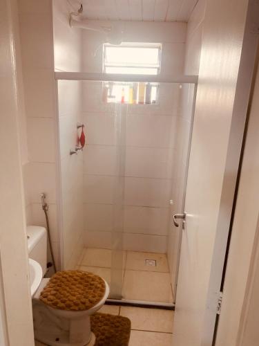 a bathroom with a shower with a toilet at Acalmaria Residence in Macaé