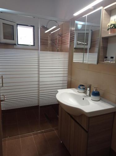a bathroom with a sink and a shower at ARGOSTOLI sunset in Argostoli