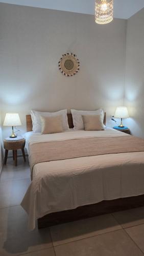 a bedroom with a large bed with two lamps at Chalet Weekend in Borjomi