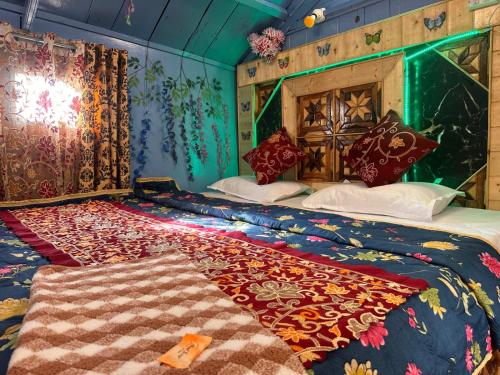 a bedroom with two beds with a blanket on it at H.B Rocket paradise in Srinagar