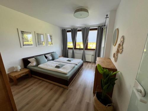 a bedroom with a bed and a couch in a room at Erholung im Trave Kieker 004 mit Pool und Sauna in Lübeck