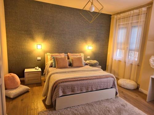 a bedroom with a large bed with a gray wall at Le Lenze in Pozzilli