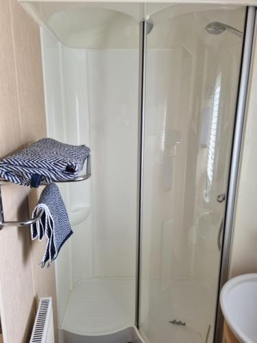 a shower with a glass door in a bathroom at The View in Millom