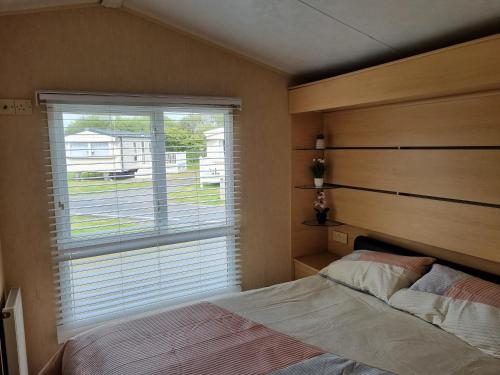 a bedroom with a bed and a large window at The View in Millom