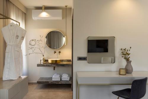 a bathroom with a white sink and a mirror at PERATZADA central suite in Argostoli