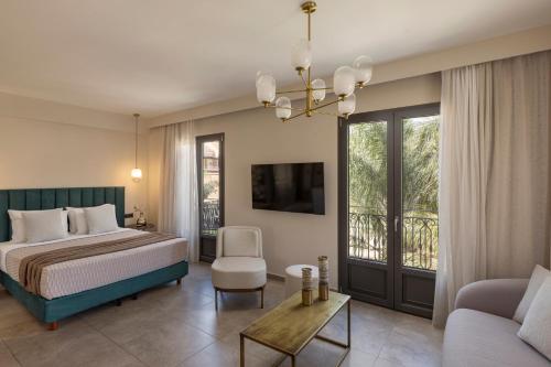 a bedroom with a bed and a living room at PERATZADA central suite in Argostoli