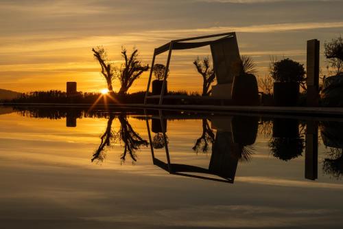 a reflection of the sunset in a body of water at Idou Malabata Beach and SPA in Tangier