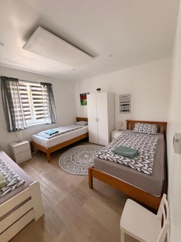 a bedroom with two beds and a window at Apartmán Provence in Doksy