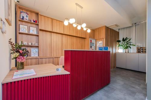 a red counter in a room with wooden walls at P23 Apartments in Bratislava