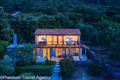 a house on a bridge with lights on at Hidden Beach Villa Biankura in Smokvica