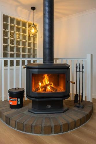 a fireplace in the middle of a living room at Berkeley Waterfront - Family & Pet Paradise in Berkeley Vale