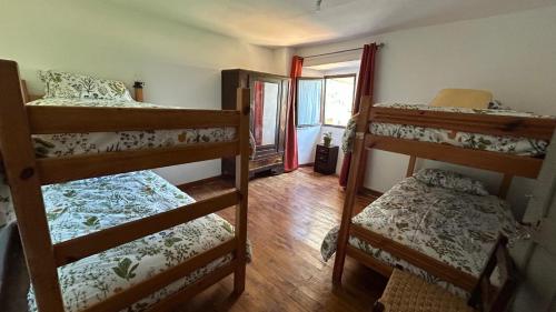 a room with three bunk beds and a window at Gaia Merindades in Salinas de Rosío